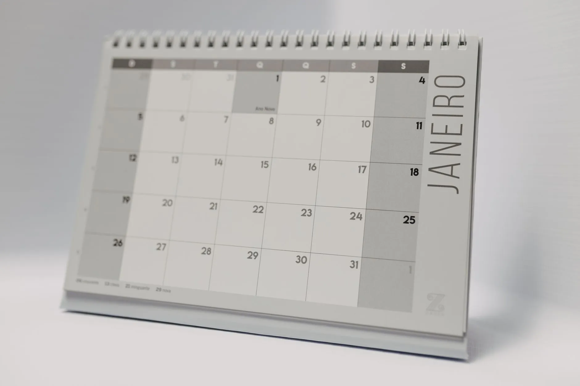 A minimalist desk calendar open on a month view.