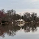 House on a lakeshore reflected in the water.