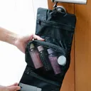 Black travel organizer pouch with toiletries.
