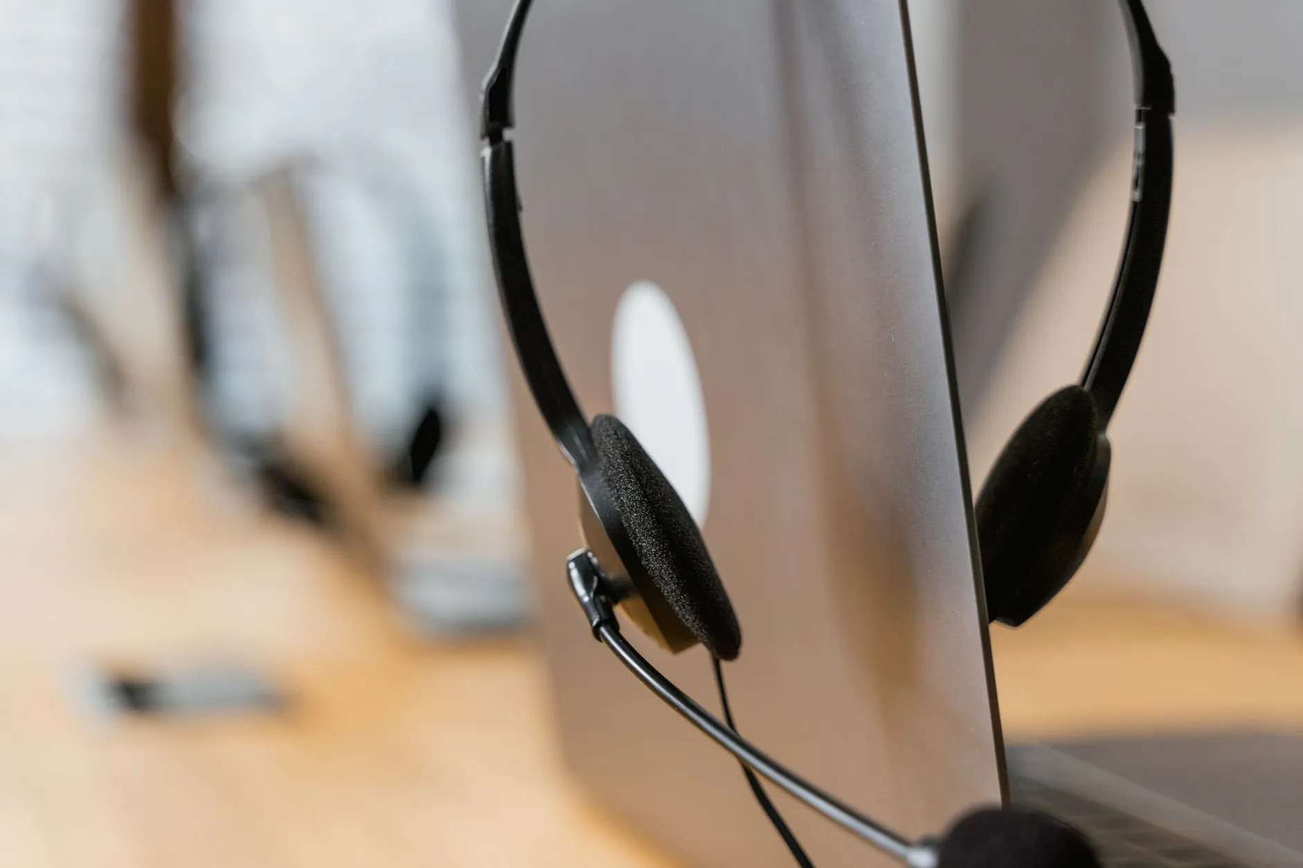 A headset resting on an open laptop.